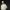 Musician Che Lingo wearing a cream outfit, in front of a black background