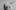 Black and white image of a person trying on suit trousers over their head