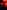 Someone holding a microphone being lit by red lighting point gun fingers to the ceiling