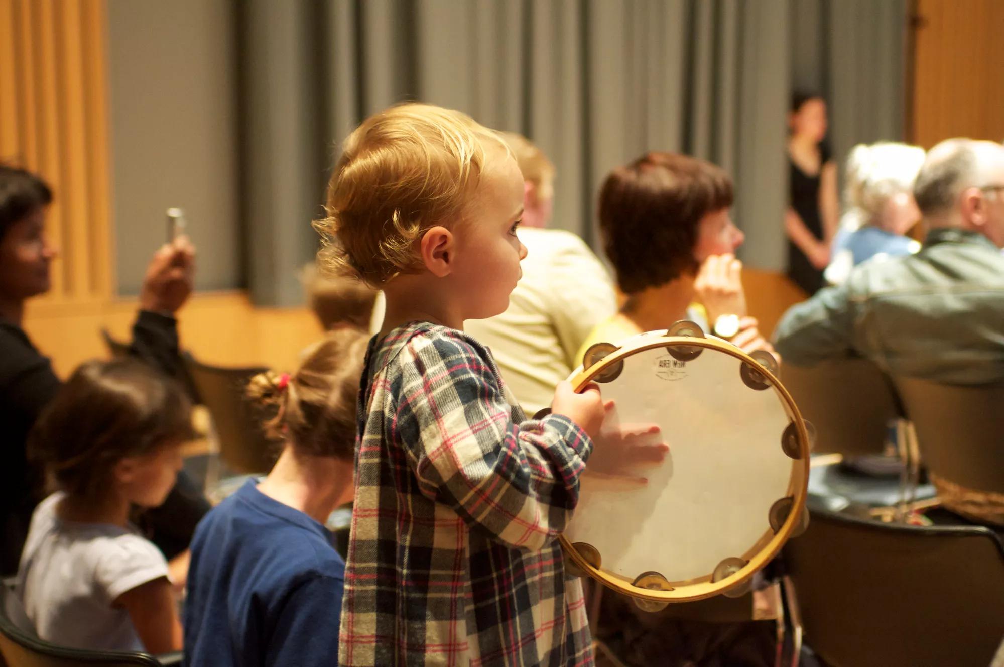 Child playing the tambourine 