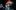 A blurred image of a cellist and dancers in motion 