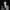 Black and white photo of author Joelle Taylor looking at the camera wearing a checkec suit
