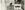 A woman in a headscarf looks at a picture within an exhibition in the Royal Festival Hall foyer space