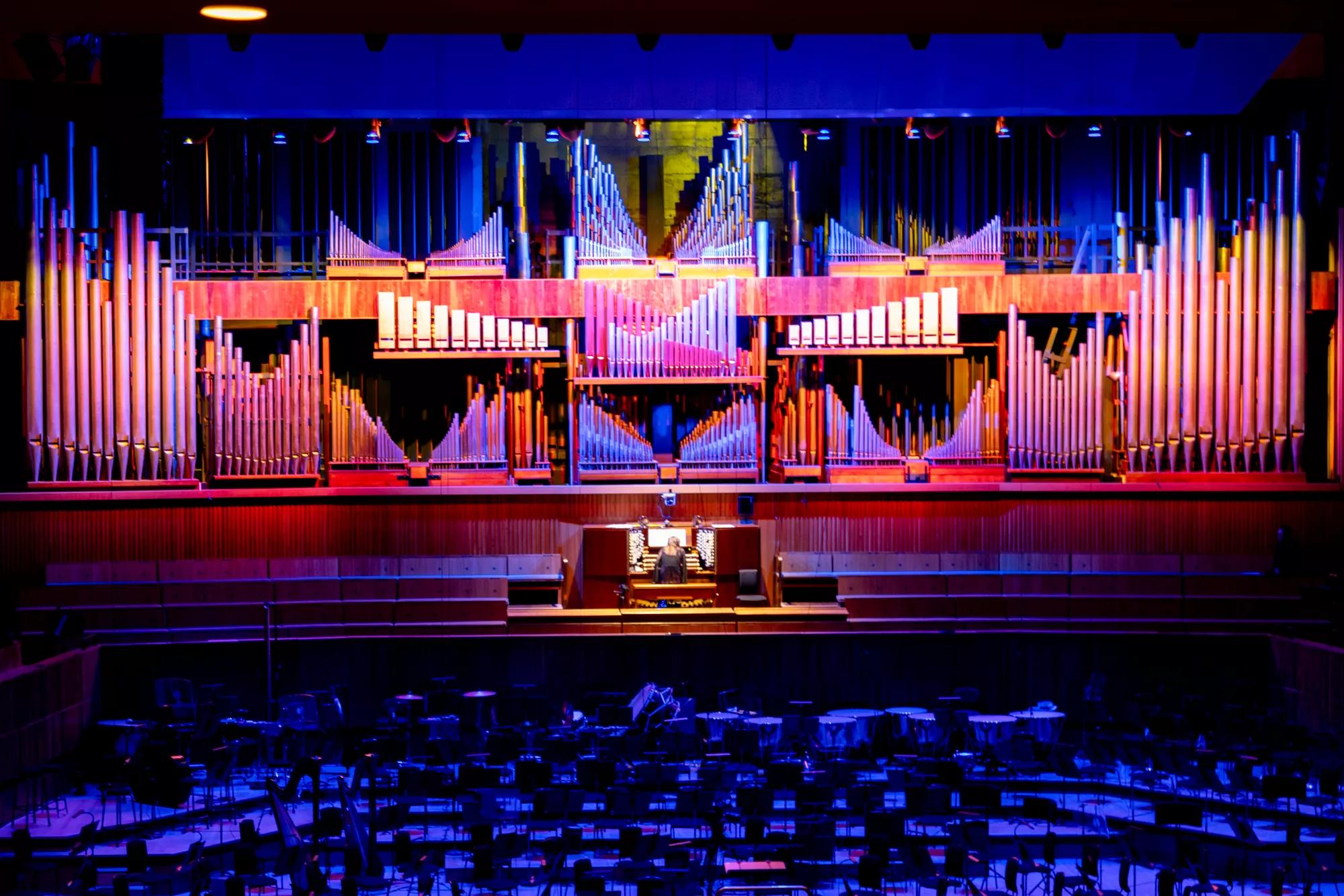 Organist Carol Williams plays the Royal Festival Hall organ whiich is illumiated with bold colours