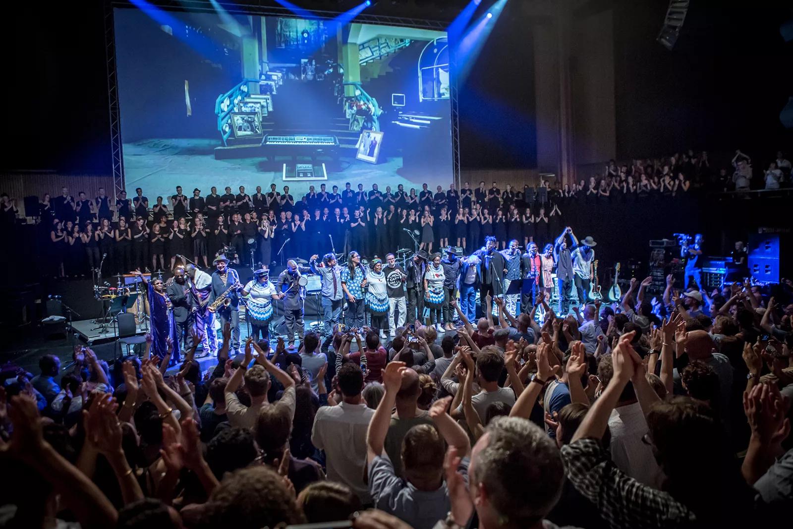 The performers of Atomic Bomb! are given a standing ovation on stage at the climax of the Meltdown 2015 concert