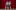 Two performers stand on stage in front of a red curtain and look out to the side of the auditorium. 