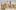 Performers on set dressed up as scarecrows surrounded by hay bales