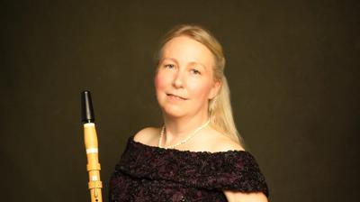 Artist sitting by a piano
