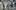 A blurred image of a group of musicians in a studio 