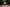 The artist, Aditya Prakash, sat playing an instrument, in a living room setting.