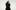 Little Simz in a black dress with her arms folded. Her hair is covering one eye.