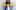 Jeffrey The KiDDD, a young Black man with long dreads  wearing pink tinted sunglasses and a light blue puffer jacket, with two toned blue jeans. The word 'Playlist' sits over the top of him in yellow type.