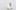 Artwork on a shelf attached to a wall with a black line saying \'here you are\' leading to a plaque on the front of the shelf
